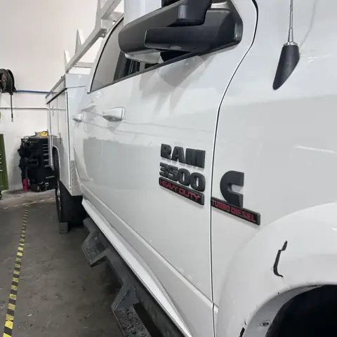 Ram 3500 Heavy Duty Cummins Turbo Diesel work truck with service body in the Rapid Diesel Repair shop bay